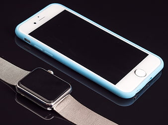 White Smartphone With Blue Case And Smartwatch On Black Surface