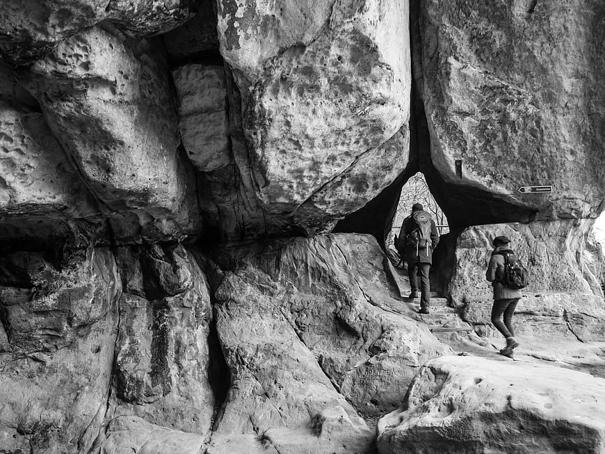 Hikers Exploring Elbe Sandstone Rock Formation in Black and White