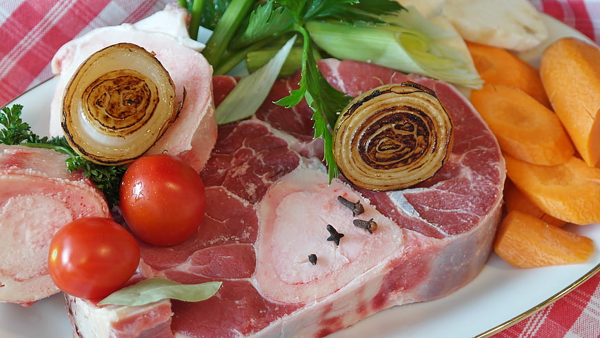 Raw beef bone marrow with vegetables for soup preparation