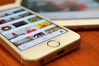 Close-up of Gold Smartphone Displaying Social Media Feed