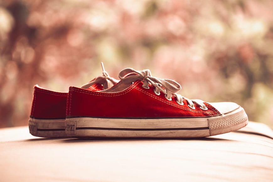 Vintage Red Canvas Sneakers on Wooden Surface