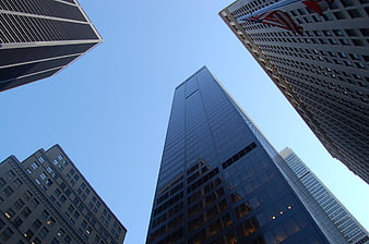 Low angle view of modern skyscrapers against blue sky
