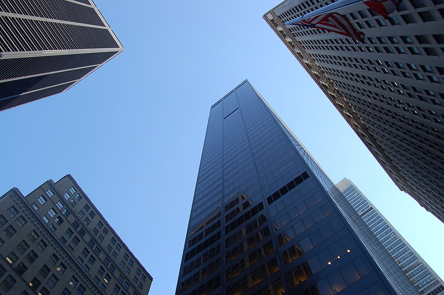 Low angle view of modern skyscrapers against blue sky