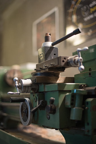 Close-up of vintage green industrial lathe machine