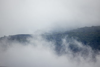 Misty Mountain Ridge Through Thick White Fog