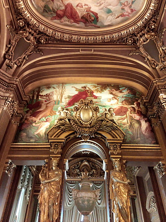 Ornate gold ceiling frescoes and statues in a Parisian cathedral interior