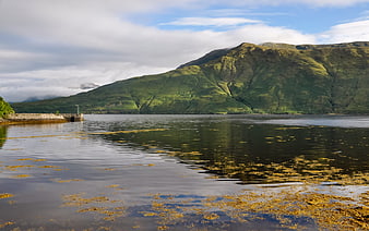 Serene Irish Lake with Green Mountains and Seaweed