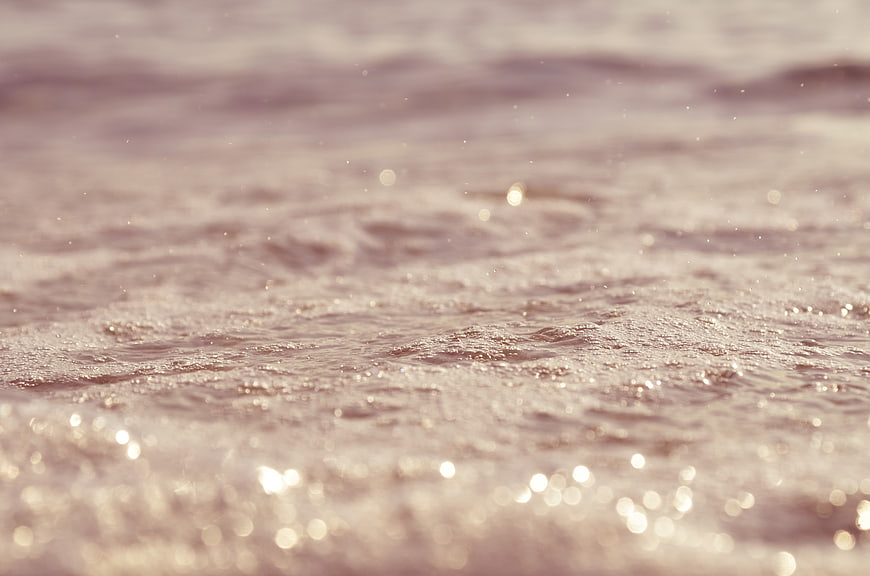 Sparkling Ocean Water Surface with Soft Bokeh Background