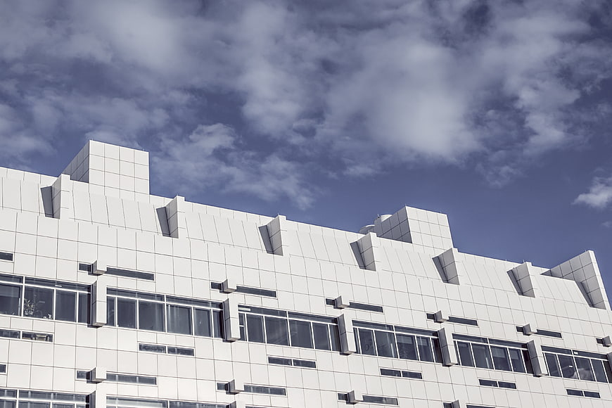 Modern White Geometric Building Facade Against Blue Sky