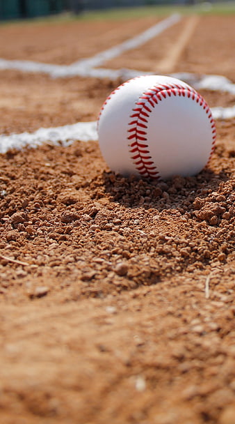 Close-Up Baseball on Dirt Field Near White Chalk Line