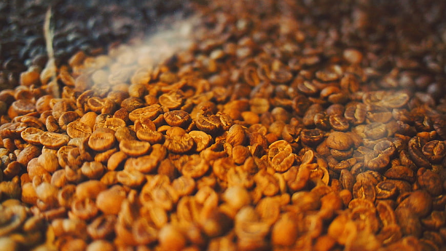 Close-up of steaming roasted coffee beans