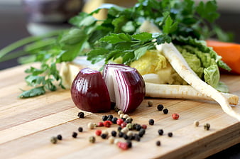 Fresh vegetables and spices on wooden cutting board