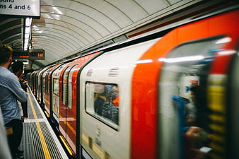 Motion Blur of Red and White Subway Train Arriving at Station