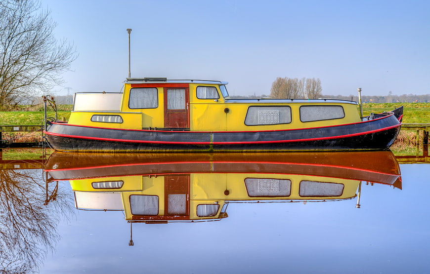 Yellow Narrowboat Reflection in Calm Canal Water