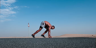 Athletic Man Stretching on Desert Road