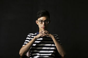 Portrait of young Asian man with glasses in striped shirt