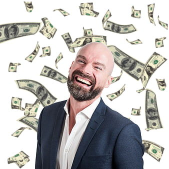 Happy bald businessman in suit with falling dollar bills on white background