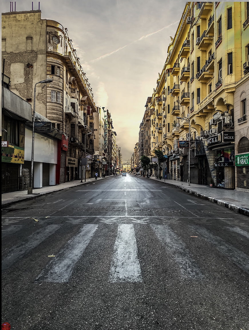 Empty Urban Street with Yellow Buildings and Crosswalk