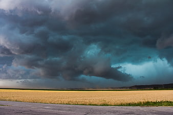 Dramatic Dark Storm Clouds Over Golden Wheat Field