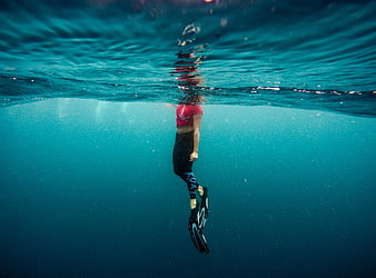 Woman Snorkeling Underwater in Blue Ocean