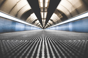Motion blur view of empty escalator in modern tunnel