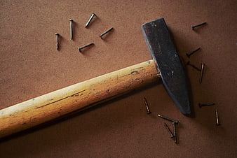 Vintage Hammer and Nails on Brown Background