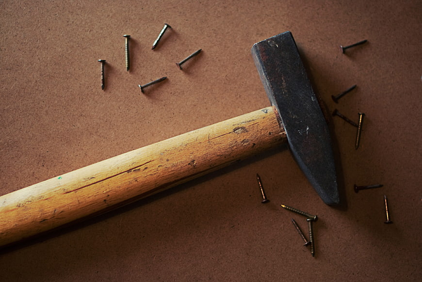Vintage Hammer and Nails on Brown Background
