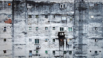Weathered Concrete Apartment Building Facade with Windows