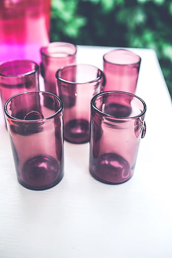 Set of pink drinking glasses on white table