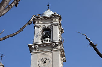 Low angle view of ornate church bell tower against blue sky