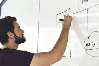 Man drawing website wireframe on whiteboard