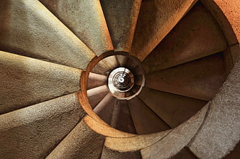 Top-down view of a textured stone spiral staircase