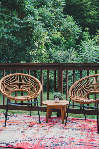 Cozy Outdoor Patio with Wicker Chairs and Colorful Rug