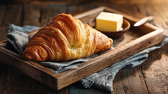 Golden Flaky Croissant with Butter on Rustic Wooden Tray