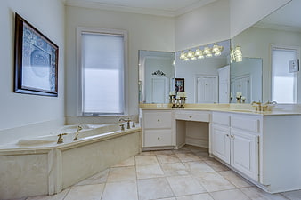 Luxurious White Marble Master Bathroom With Corner Bathtub And Vanity