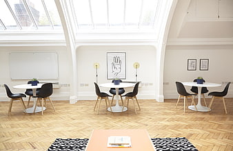 Bright Modern Office Lounge With White Tables And Black Chairs
