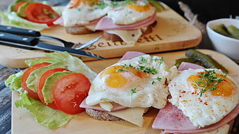 Open-faced fried egg sandwiches with ham and fresh salad
