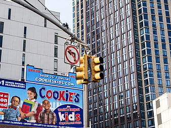 Urban Traffic Light and Cookie's Kids Billboard in City