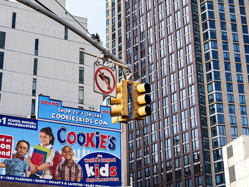 Urban Traffic Light and Cookie's Kids Billboard in City