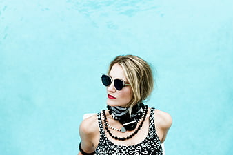 Fashionable Woman in Sunglasses by Blue Pool