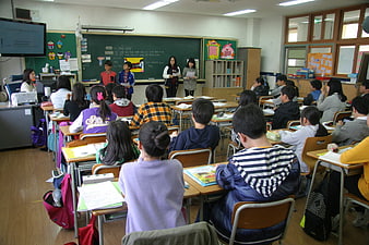 Students in a classroom listening to a presentation