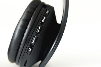 Close-up of black wireless headphones with control buttons