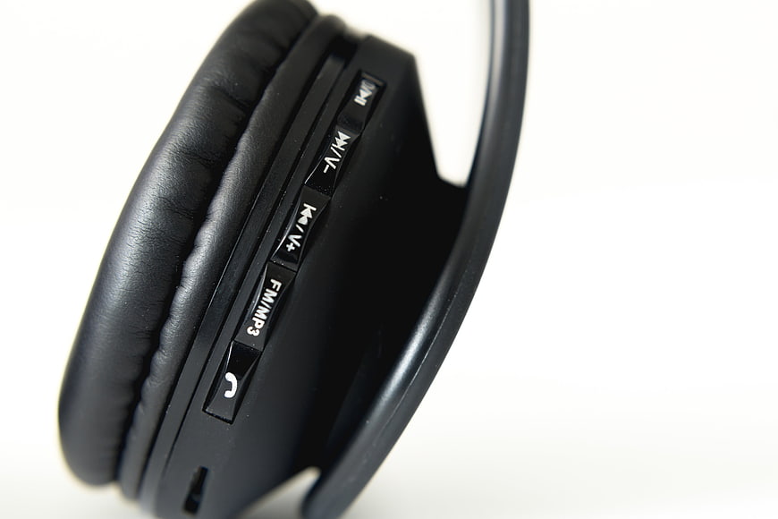 Close-up of black wireless headphones with control buttons