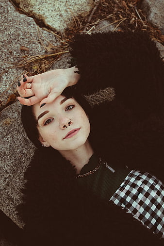 Young Woman Model Portrait Lying On Rocks