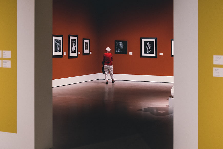 Senior woman viewing art in a museum gallery
