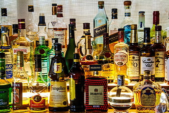 Collection of various liquor bottles on a bar shelf