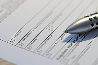Close-up of silver pen on German business application form