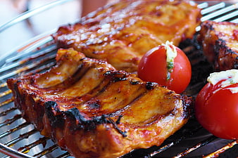 Close-up of Grilled BBQ Ribs and Tomatoes on Grill