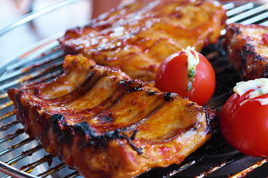 Close-up of Grilled BBQ Ribs and Tomatoes on Grill