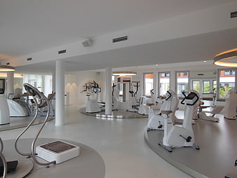 Modern luxury fitness center with white exercise equipment